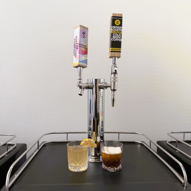 A two-tap Perpetual kegerator with freshly poured drinks